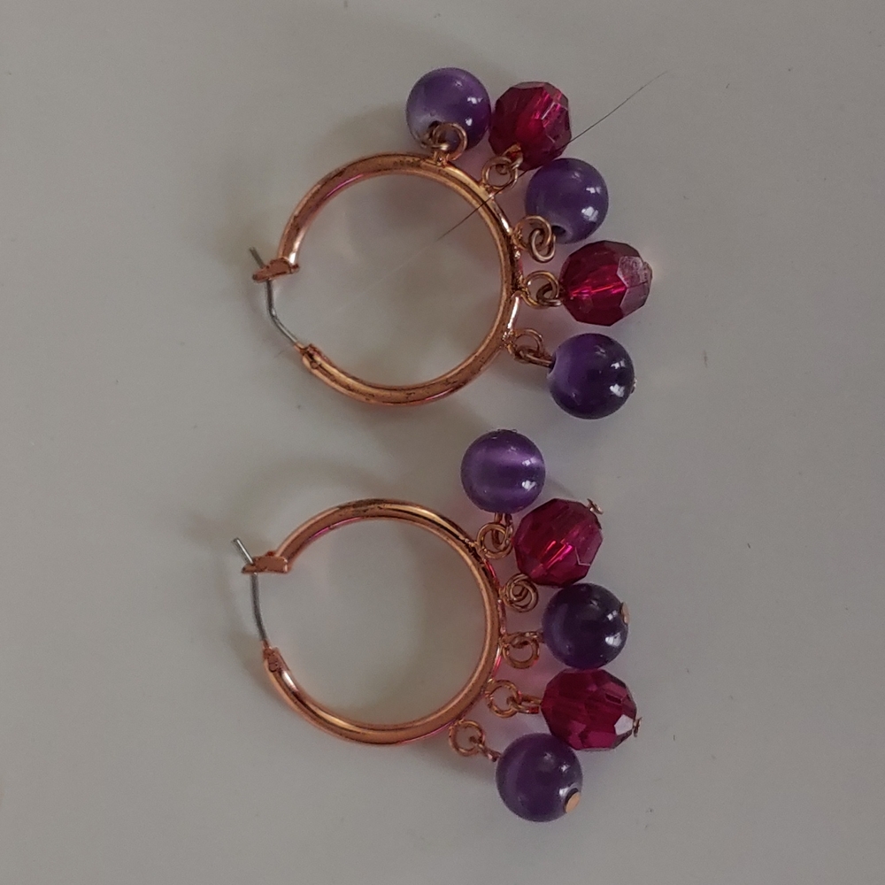 Gold hoop earrings with purple and pink beads
